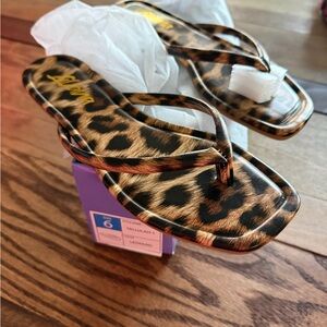 These are Tallulah leopard print thong sandals